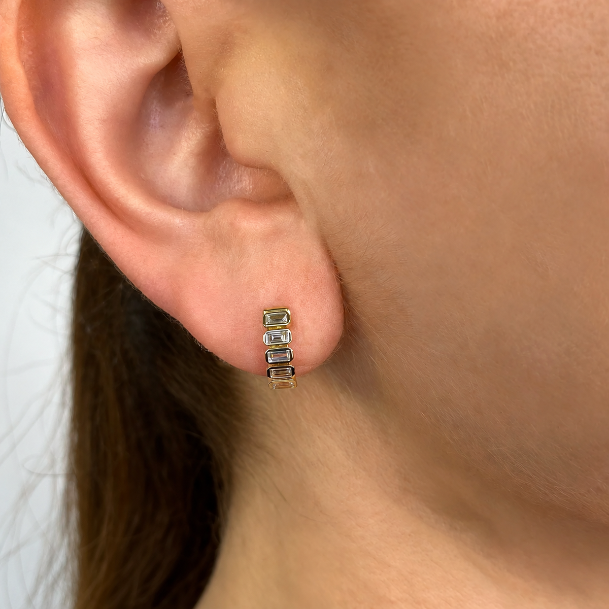 14K Gold Baguette Bezel Huggie Earrings Worn on Ear