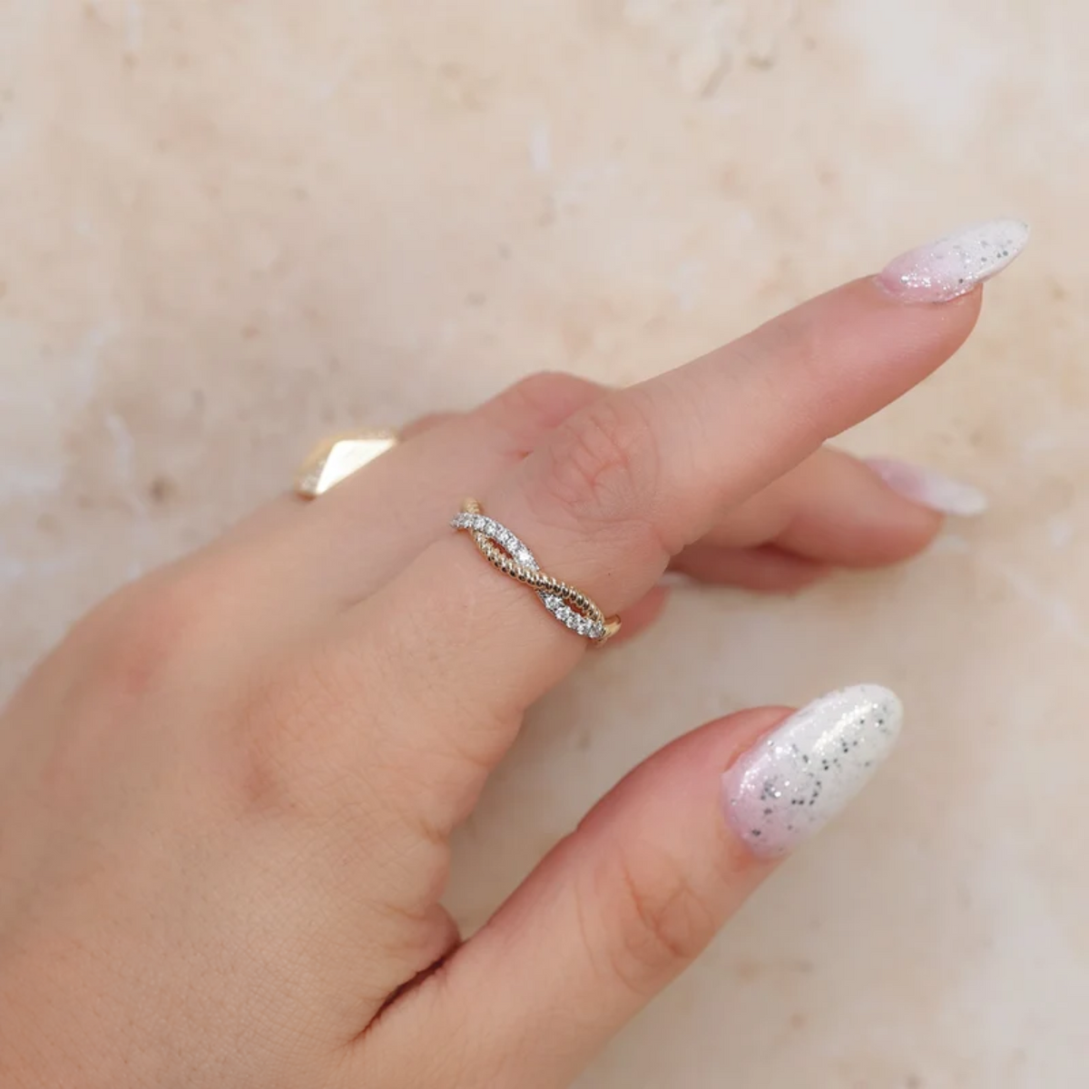 14K Gold Diamond Twisted Ring Worn on Finger