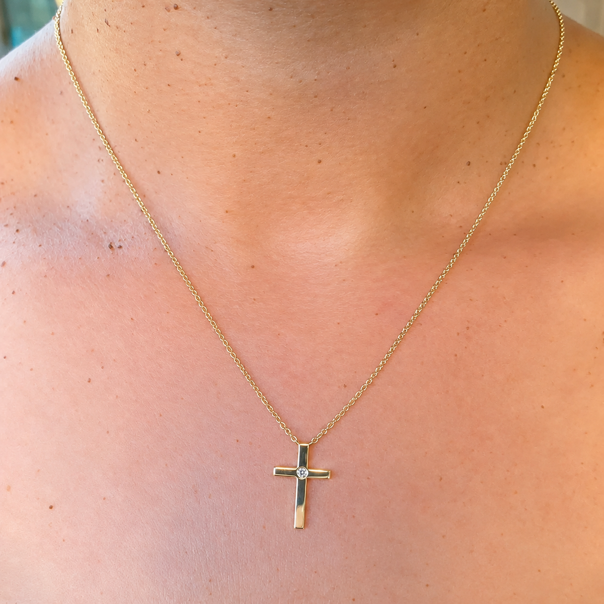 14K Gold Diamond Solitaire Cross Necklace Worn on Neck