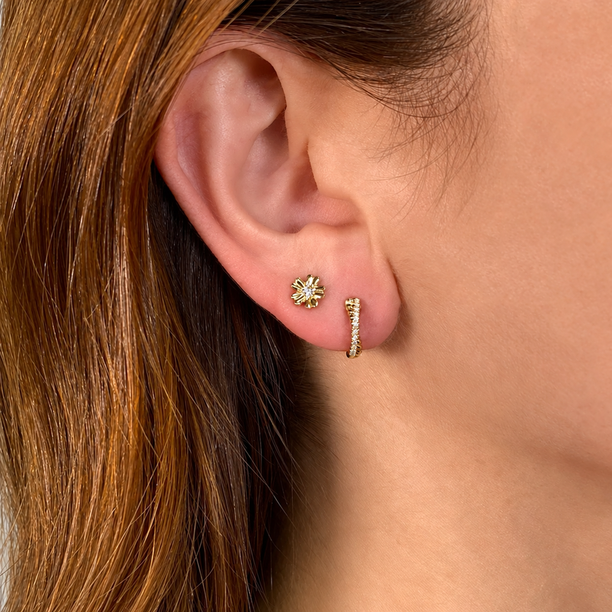 14K Gold Diamond Crossover Huggie Earring Worn on Ear