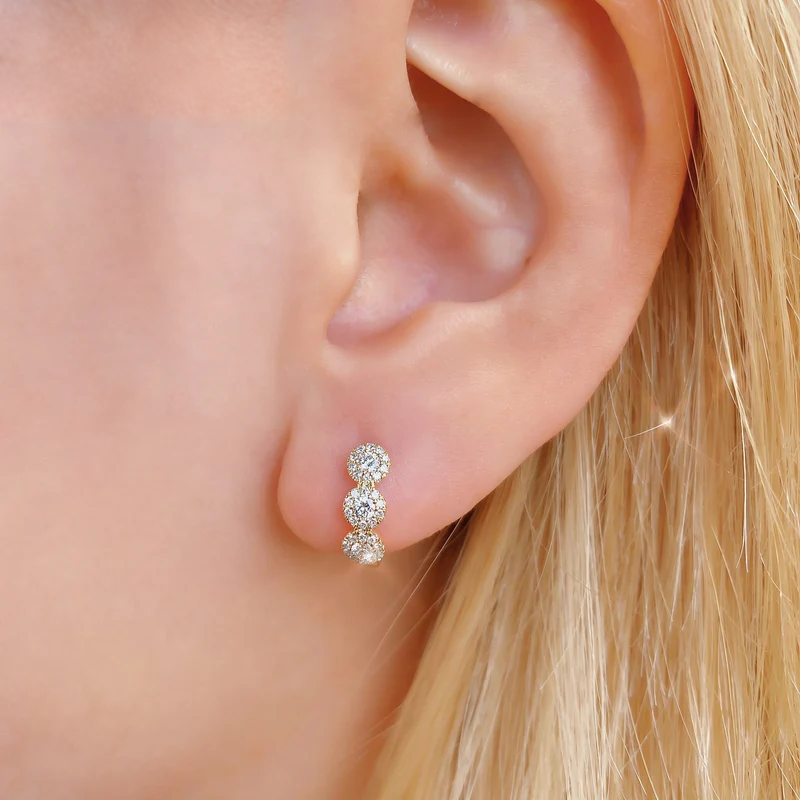 14K Gold Diamond Halo Huggie Earrings Worn on Ear
